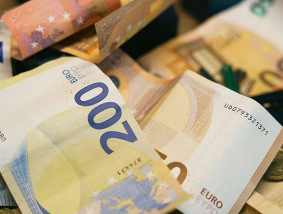 Close-up of euro banknotes and coins.