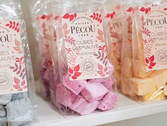 Sachets de cubes de guimauve Maison Pécou, dont une version à la framboise, présentés en rayon.