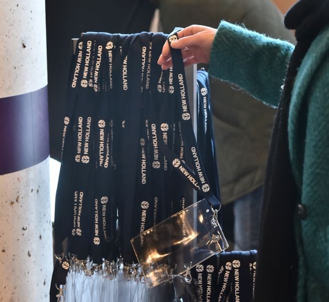 Hand holding a bunch of lanyards