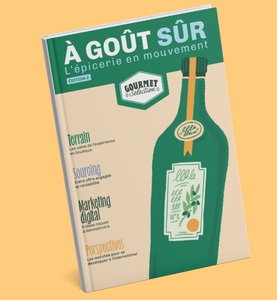 Couverture de la deuxième édition du magazine À Goût Sûr de Gourmet Selection, illustrée par une bouteille stylisée et mettant en avant des thématiques telles que l’expérience en boutique, le sourcing, le marketing digital et l’international.