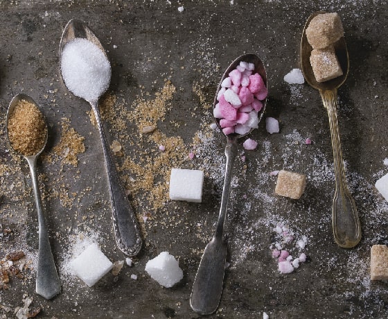 Spoon with different sugars